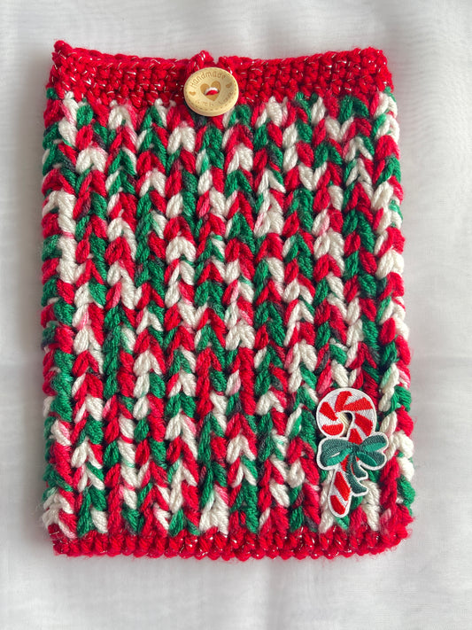 Crocheted pouch with red, green, and white pattern on a light gray background